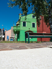 Burano island in in venice in italy with green house.