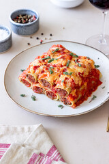Cannelloni with meat, cheese, tomatoes and thyme. Italian cuisine.
