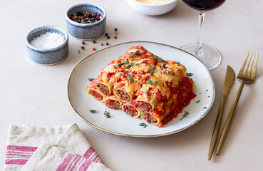 Cannelloni with meat, cheese, tomatoes and thyme. Italian cuisine.