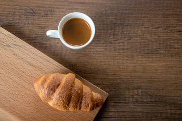 Croissant with espresso in white cup,top view	