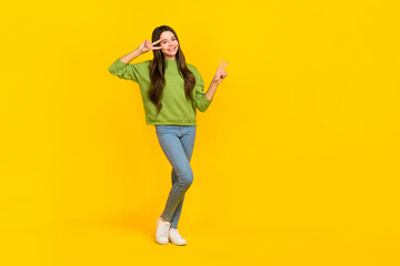 Fototapeta na wymiar Full length photo of young cheerful girl show fingers peace cool v-symbol isolated over yellow color background