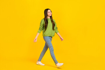 Fototapeta na wymiar Full body profile side photo of young pretty girl go look empty space denim isolated over yellow color background