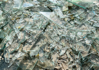 Background of broken glass close-up. The texture of broken glass