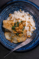 white cod with homemade basil pesto and roasted pine kernels