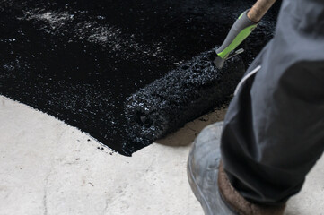Waterproofing the floor in a private house, applying liquid resin to the floor, concrete screed and...