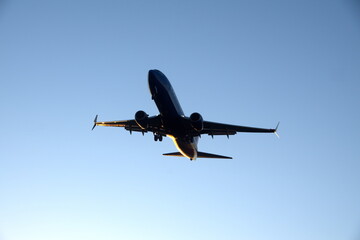 Commercial jet flying, in silhouette, in the evening, in Fort Lauderdale, Florida, USA