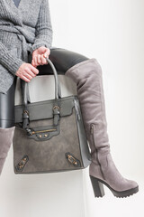 gray women's boots with a handbag
