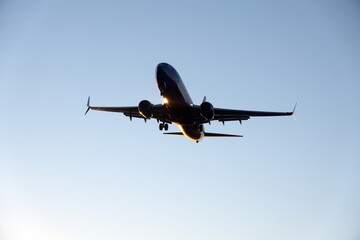 Commercial jet flying, in silhouette, in the evening, in Fort Lauderdale, Florida, USA