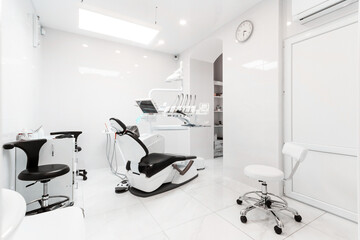 Dentist's dental office interior with unit, tools, lamps, ergonomic chair