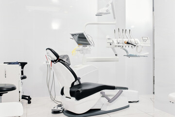 Dentist's dental office interior with unit, tools, lamps, ergonomic chair