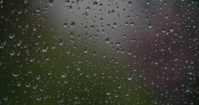 Raindrops running down a sheet of glass give a sense of melancholy calm. Ideal backdrop or abstract piece. 