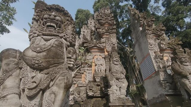 stone carving of gods guarding an entrance to a temple on Bali