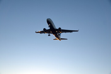 Commercial jet flying, in silhouette, in the evening, in Fort Lauderdale, Florida, USA