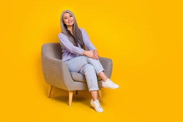 Fototapeta na wymiar Full body photo of adorable cute cheerful business lady have break from work sit chair isolated on yellow color background