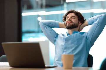 Portrait of smiling business man relaxing on chair at office