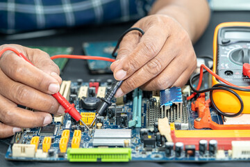 Fototapeta na wymiar Technician repairing inside of mobile phone by soldering iron. Integrated Circuit. the concept of data, hardware, technology.