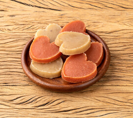 Sweet potato candy, typical brazilian june festival food over wooden table. Festa junina