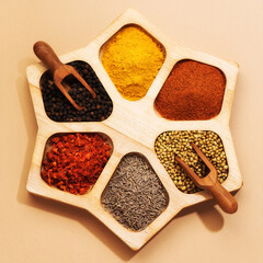 Spices in a wooden box top view. Spices background