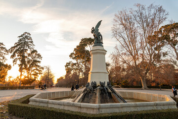 Madrid, Spain. The Fuente del Angel Caido (Monument of the Fallen Angel), a fountain located in the Buen Retiro Park - obrazy, fototapety, plakaty