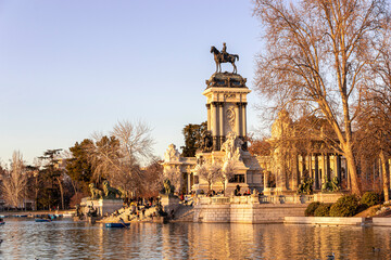 Fototapeta na wymiar Madrid, Spain. Monument to King Alfonso XII in Buen Retiro Park (El Retiro), situated on the east edge of an artificial lake near the center of the park