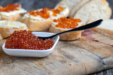 red salmon or trout caviar with white baguette and butter