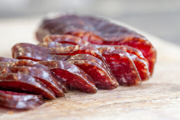 sliced piece of cured sausage on the table
