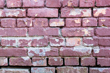 Background of old vintage dirty brick wall with peeling plaster and paint