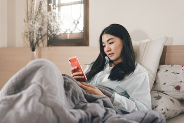 Young adult lonely single woman using smartphone for surfing the net telemedicine and mental health