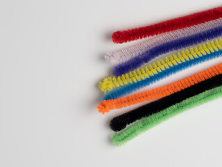 rainbow pipe cleaner ends  on a white background