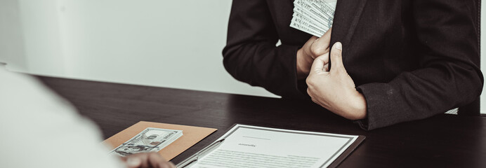 Businessmen give dollars to bribe employees in signing contracts to buy illegal land and real estate, Business fraud and social injustice, corruption and bribery concept.