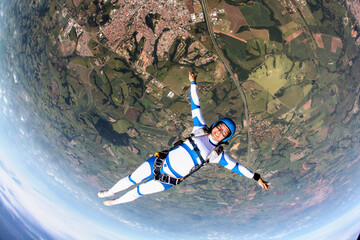 Beautiful woman skydiving in freefall, adventure freedom concept