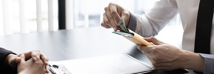 Businessmen give dollars to bribe employees in signing contracts to buy illegal land and real estate, Business fraud and social injustice, corruption and bribery concept.