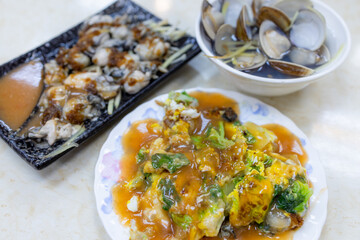 Taiwanese cuisine with oyster omelet, clam soup and fresh oyster with sauce
