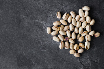 Organic pistachios. Pistachios in shell and cleaned nuts. Flat lay, top view, cop space.