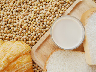 Soy milk on wood cutting board and some bread and croissant