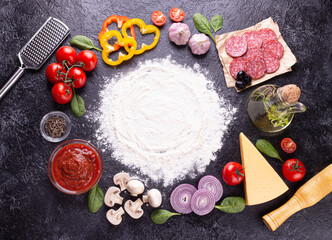 Pizza ingredients on black background
