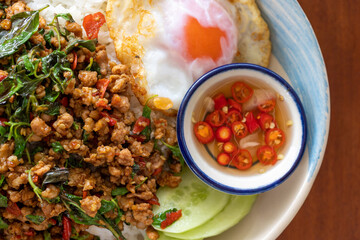 Close up of pork basil and fried egg with chili fish sauce