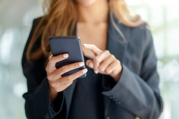 Woman using smartphone to send text , work or play social media.