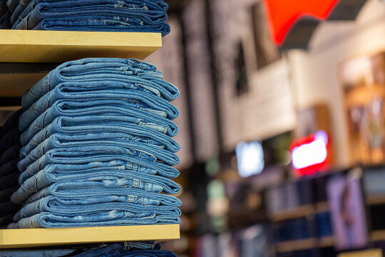 Stack of blue jeans onshop shelves