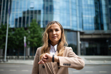 Business woman checking the time on her watch