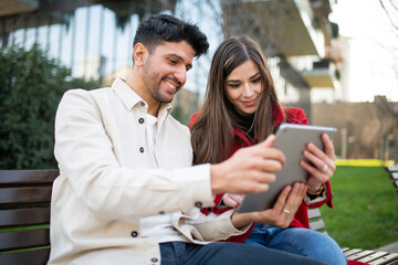 Couple using a tablet outdoors