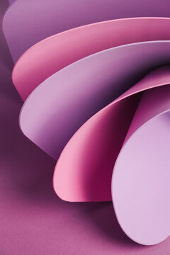 Violet pastel wavy paper sheets on a purple background. Abstract colorful backdrop