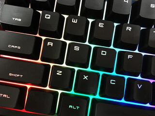 Modern gaming keyboard with bright backlit keys on the table