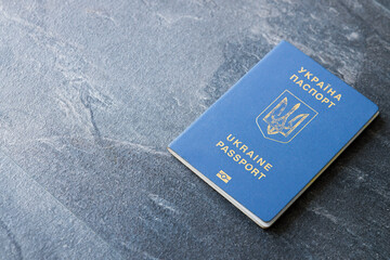 Passport of a citizen of Ukraine  on a dark background, close-up. Inscription in Ukrainian Ukraine Passport
