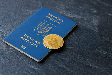 Urkainian passport with bitcoin golden coin. Urkaine currency during the war. Virtual money. Donation for Ukraine. Stop war.