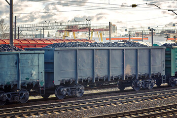 Coal freight train loaded with coal. Train cars full of coal at railway station. Train transports fossil fuel. Coal embargo, ban and restrictions concept - obrazy, fototapety, plakaty