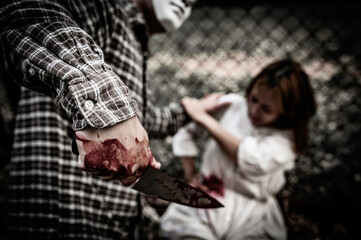 A serial killer scene is about to kill an Asian woman,concept thriller scene,Halloween festival
