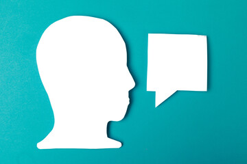  paper face and speech bubble on colorbackground copy space for text, communication, symbolic- Image