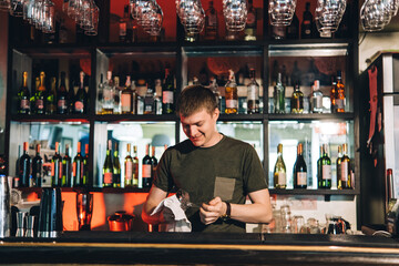 Vintage portrait of bartender creating cocktails at bar. Close up of alcoholic beverage preparation