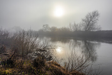 Fototapeta na wymiar Gloomy light on a misty day on the River Wye at Huntsham Bridge, Herefordshire, England UK